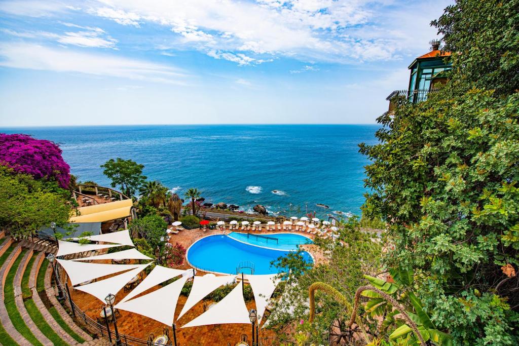 - une vue sur l'océan depuis un complexe doté d'une piscine dans l'établissement Baia Taormina - CDSHotels, à Forza dʼAgro