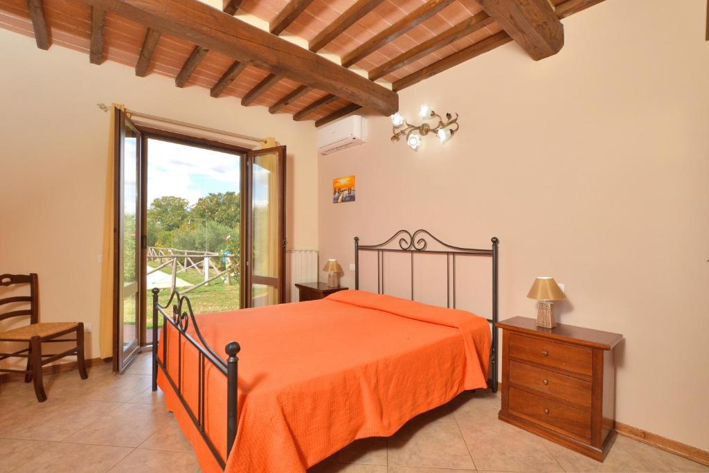 une chambre avec un lit avec un couvre-lit orange dans l'établissement Villa San Lorenzo - Happy Rentals, à Cortone 35 autres photos