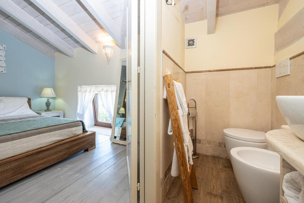 une salle de bain avec un lit, des toilettes et un lavabo dans l'établissement Palascìa Wellness Relais, à Otrante