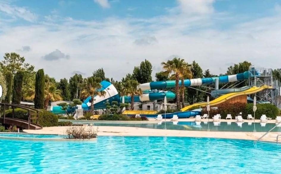 une piscine avec un parc aquatique avec un toboggan aquatique dans l'établissement Mobil Home 2 chambres, 4 à 6 personnes, Vias Plage, Camping La Carabasse - 4 étoiles, à Vias 2 autres photos