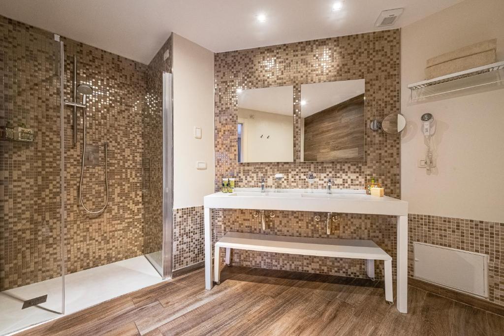 une salle de bain avec un lavabo et une douche dans l'établissement Boutique Hotel Torre Di Cala Piccola, à Porto Santo Stefano