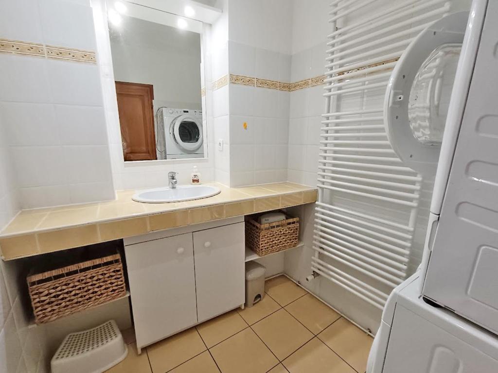 La salle de bains blanche est pourvue d'un lavabo et d'un four micro-ondes. dans l'établissement Le petit cerf, T3, wifi, cave, à Luchon