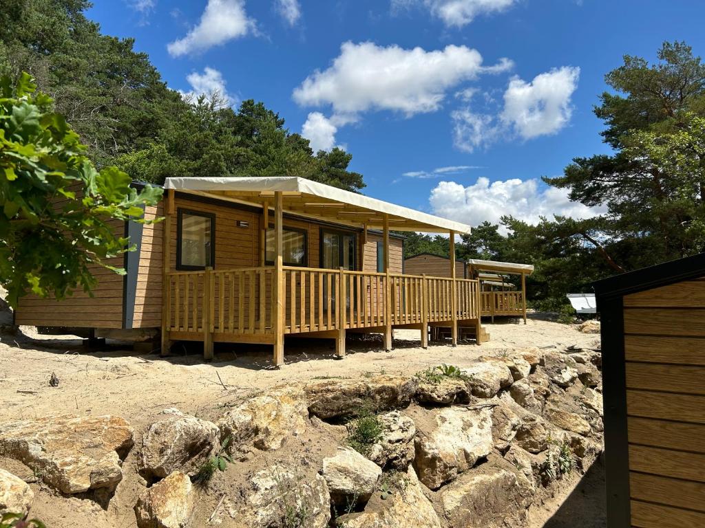 une cabine sur la plage avec un mur en pierre dans l'établissement Mobil home ile de loisirs de buthiers, à Buthiers