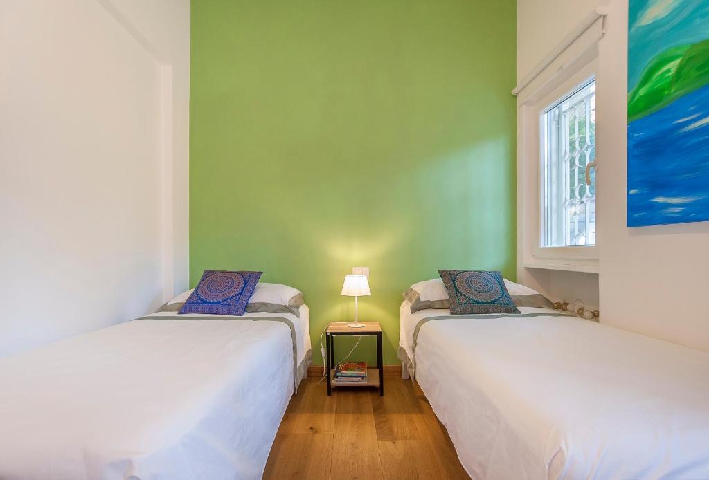 deux lits jumeaux dans une chambre avec fenêtre dans l'établissement Villa sul lago a 35 minuti da Roma, à Trevignano Romano