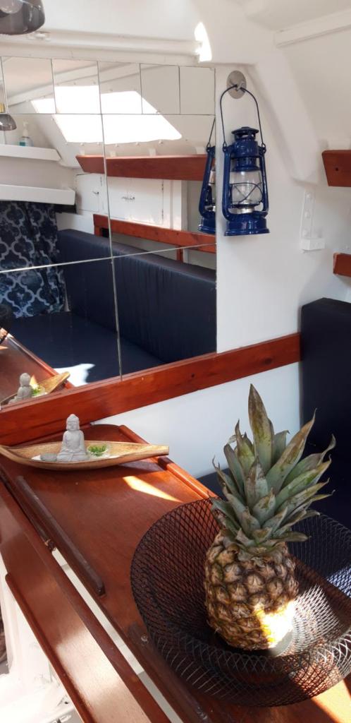 un ananas posé sur une table en bois dans l'établissement Le Nid sur l'Eau, à Sète