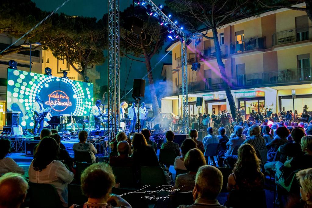 Une foule de gens qui regardent un groupe à un concert dans l'établissement Albergo Ridente, à Lido di Jesolo