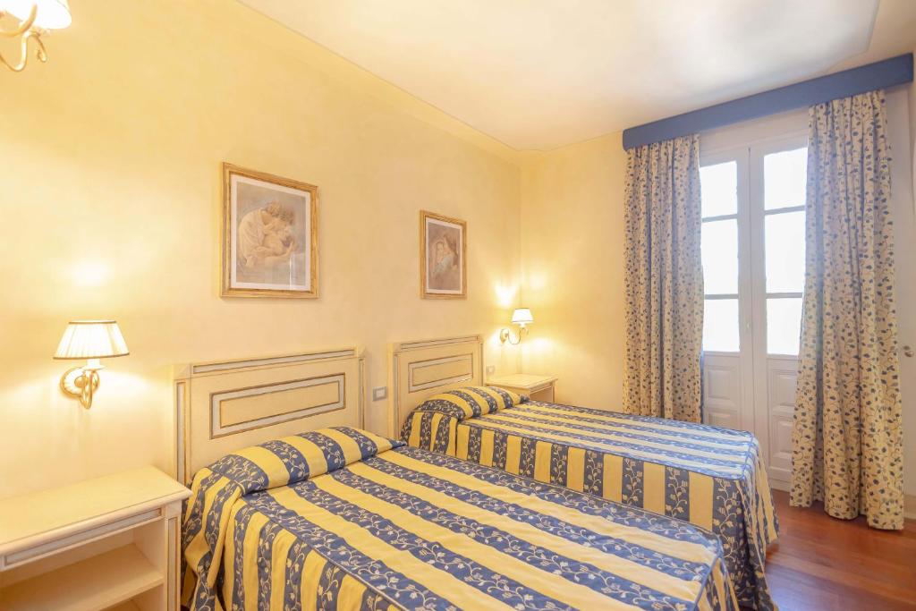 une chambre avec deux lits et une fenêtre dans l'établissement Villa La Rosa dei Venti, à Fiorino 25 autres photos