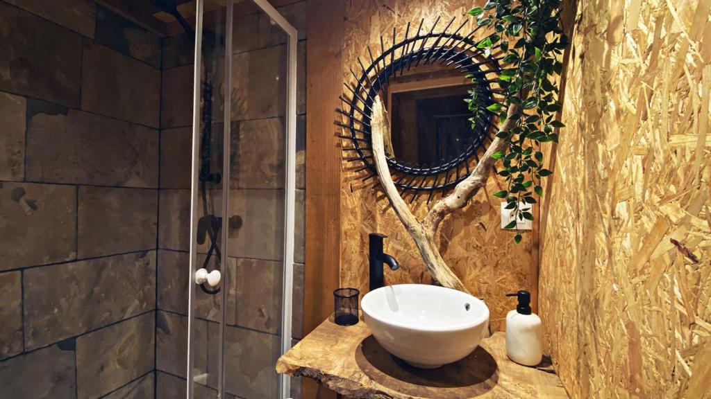 une salle de bain avec un lavabo et un miroir dans l'établissement L'étoile de Baynes, à Cerisy-la-Forêt