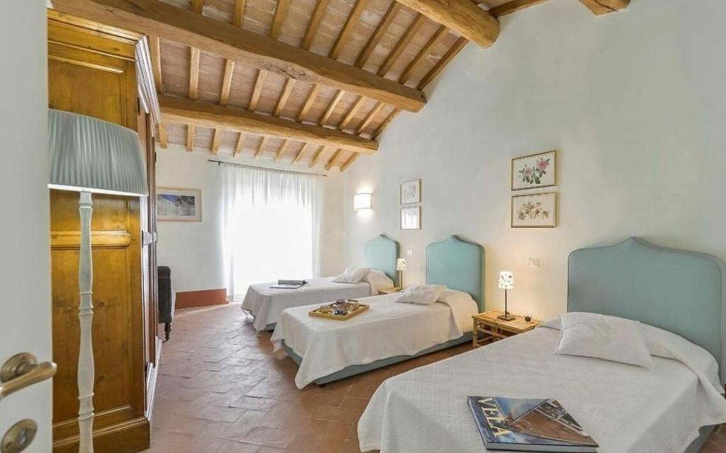 une chambre avec deux lits dans une pièce dans l'établissement Villa Lotus Magliano, à Magliano in Toscana