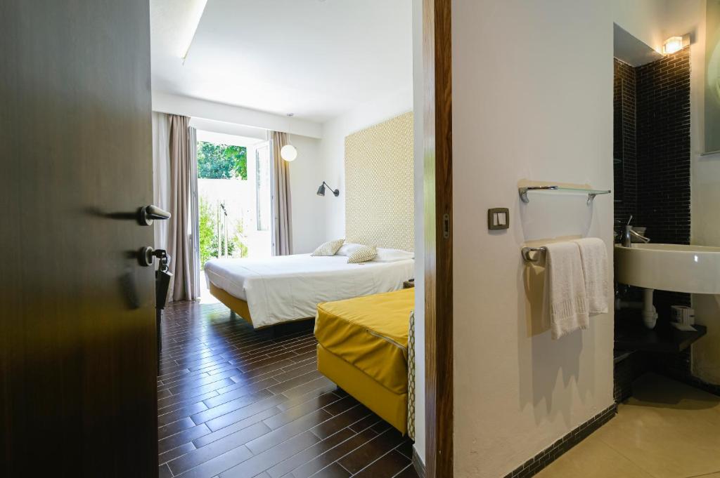 une chambre avec un lit et une salle de bain avec un lavabo dans l'établissement Marina 10 Design Hotel & SPA, à Ischia