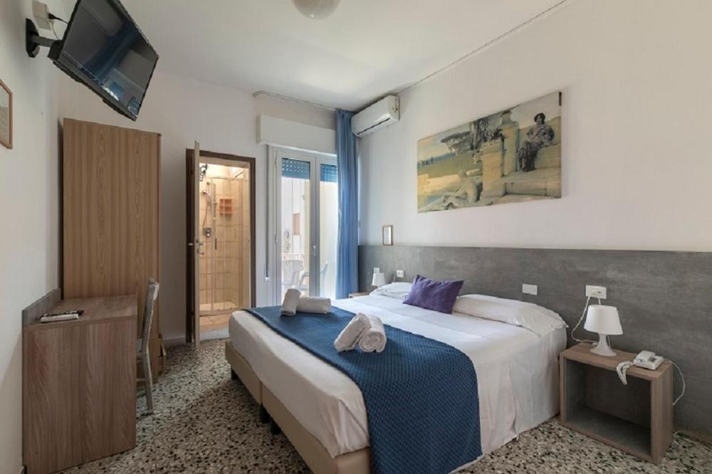 une chambre avec un grand lit et une télévision dans l'établissement Hotel Danieli, à Lido di Jesolo 98 autres photos