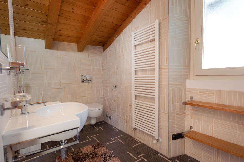 une salle de bain avec un lavabo et des toilettes dans l'établissement Luxury Villa Laglio, à Laglio