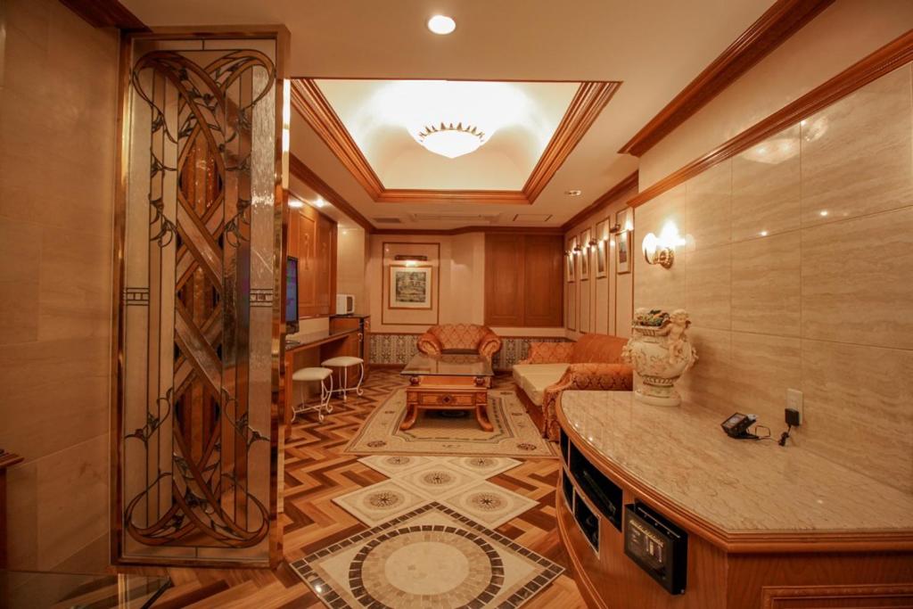 un couloir avec un salon doté d'une table dans l'établissement Hotel ShaSha Toyonaka (Adult Only), à Toyonaka