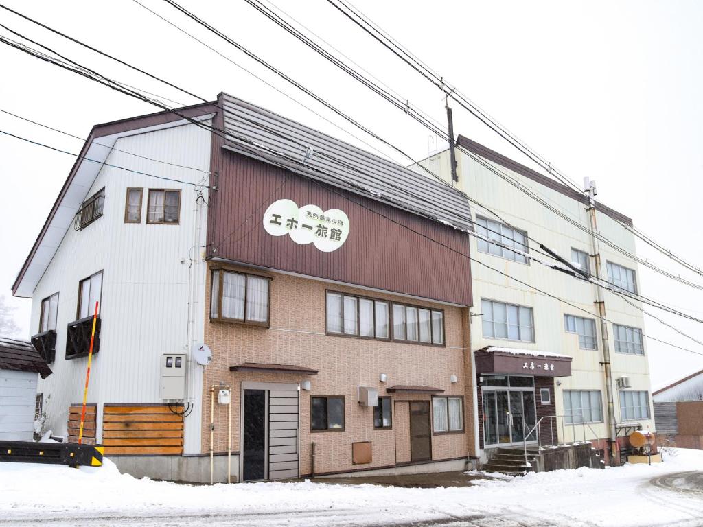 un bâtiment avec des panneaux twoaru sur le côté dans l'établissement Akakura onsen eho ryokan, à Myōkō