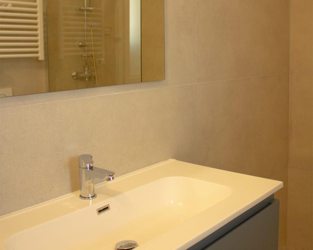 une salle de bain avec un lavabo et un miroir dans l'établissement SUNSHINE LUXURY APARTMENTS - Private Pool and Beach - Policoro Lido, à Policoro 6 autres photos