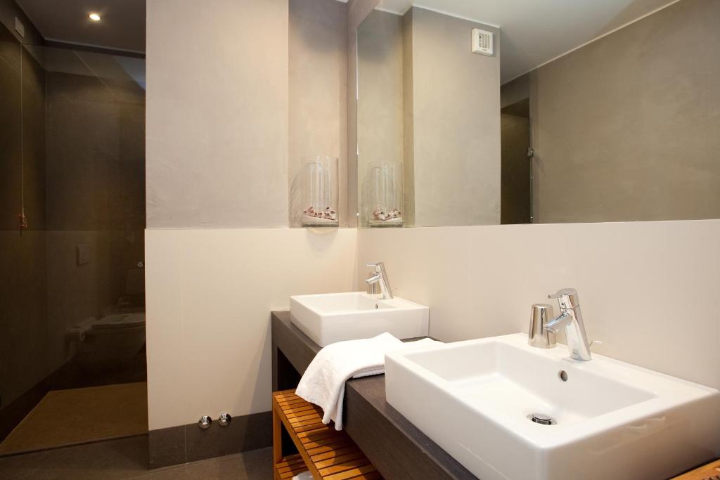 une salle de bain avec deux lavabos et un miroir dans l'établissement Hotel Ril, à Lido di Jesolo