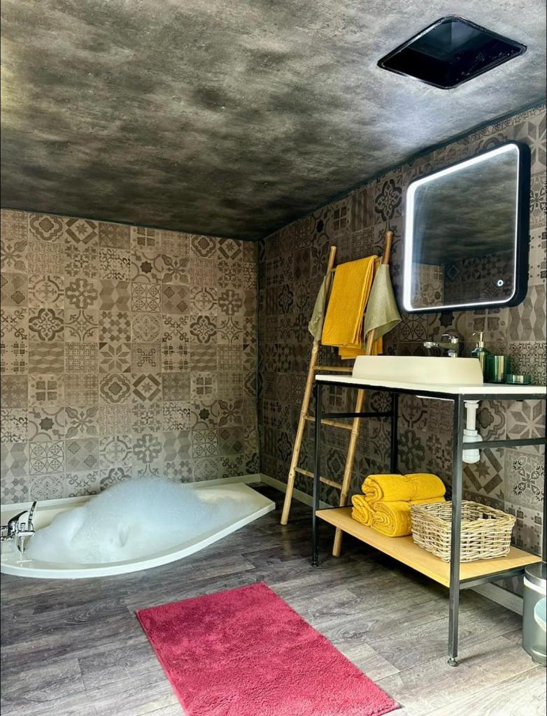 Cette chambre comprend un lit, un bureau et une télévision. dans l'établissement Magnifique Pyramide en Verre, à Montarnaud