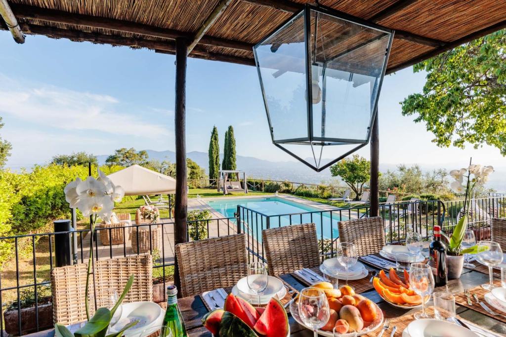 - une table avec de la nourriture et une vue sur la piscine dans l'établissement Tuscan Fizz, a traditional Stone villa with Pool, à Piaggiori