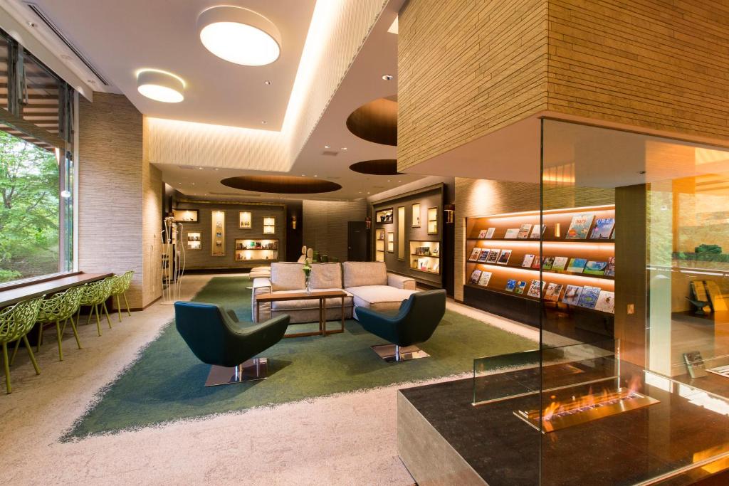 - un hall avec un canapé et des chaises dans une bibliothèque dans l'établissement Midorinokaze Resort Kitayuzawa, à Date