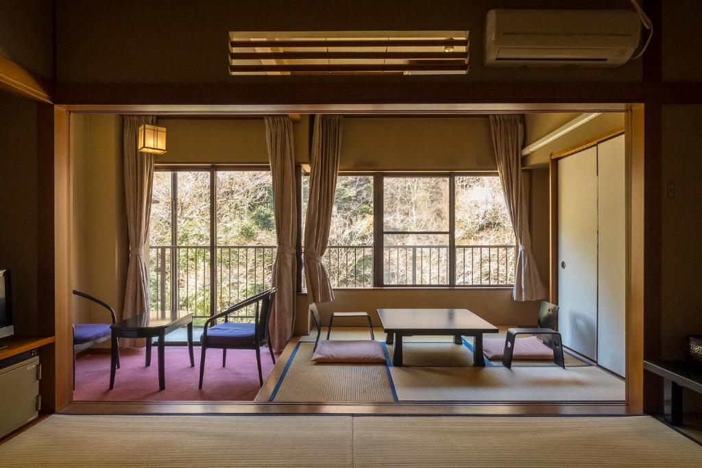 un salon avec une table et des chaises et une fenêtre dans l'établissement Shiunso, à Hakone