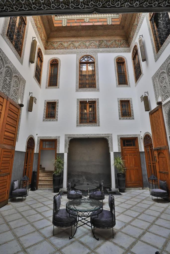 une pièce avec une table et des chaises dans un bâtiment dans l'établissement Riad Layla, à Fès
