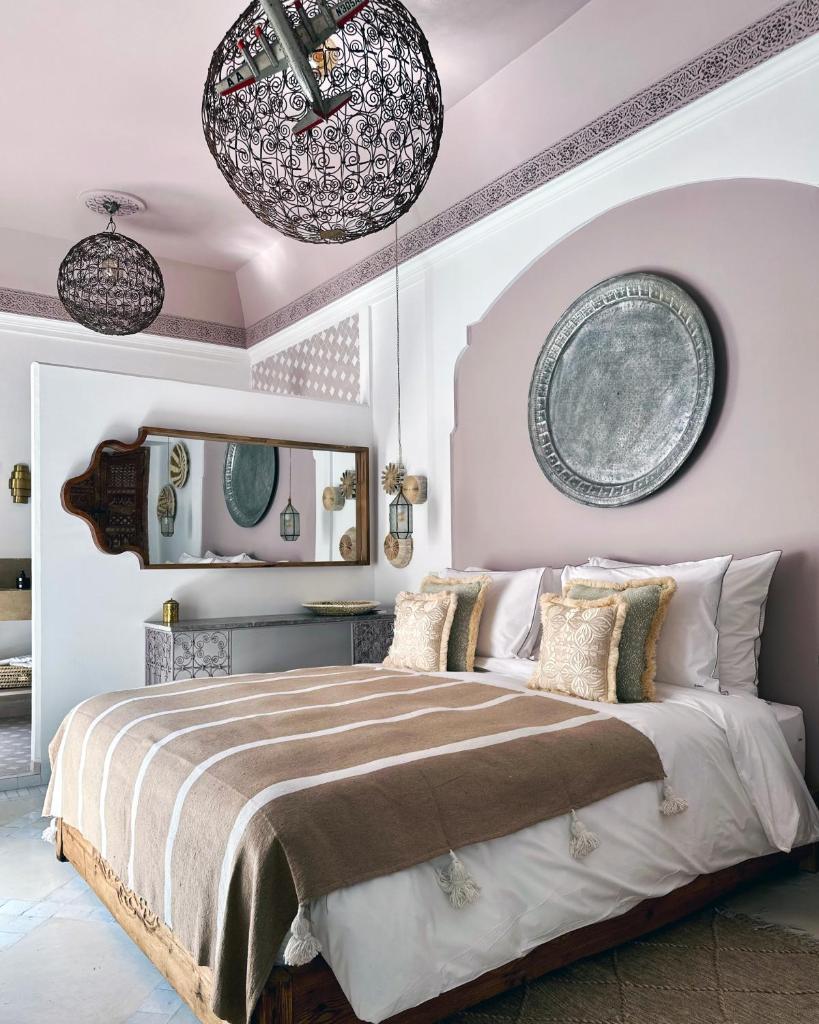 - une chambre dotée d'un grand lit avec deux plaques murales dans l'établissement Riad Jalma, à Marrakech