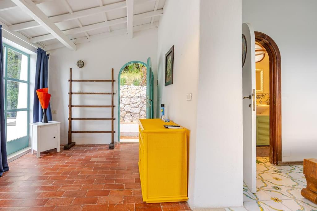 une armoire jaune au milieu d'une pièce dans l'établissement Villa Mariani - Italian Coastal Charm, à San Felice Circeo