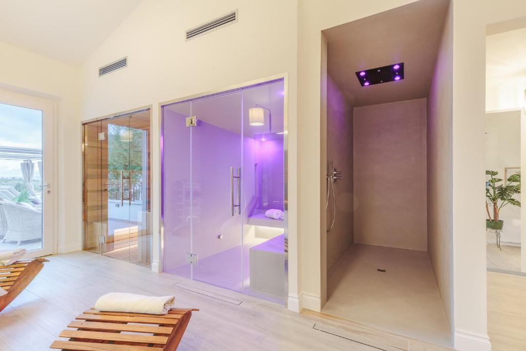 une salle de bain aux murs violets et une douche à l'italienne dans l'établissement VILLA ASTI: Where Luxury Meets Limitless View, à Capannori