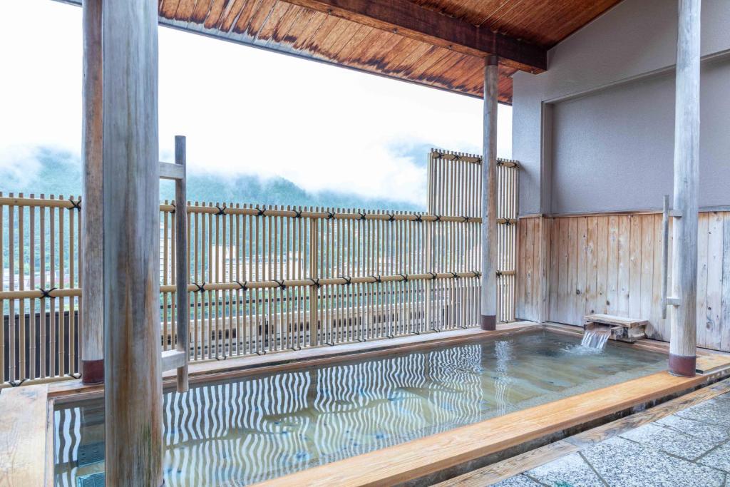 - une piscine sur une terrasse en bois avec une grande fenêtre dans l'établissement Sasara, à Gero