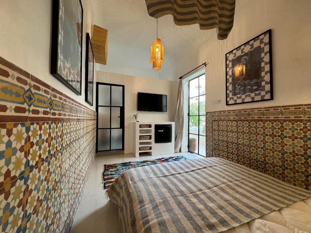 - une chambre avec un lit et un mur carrelé dans l'établissement Riad Ait El Mouden, à Agadir 37 autres photos