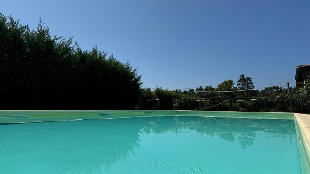 une grande piscine bleue dans une cour dans l'établissement Villa Cristina modern farmhouse with Private Pool, à Monsagrati