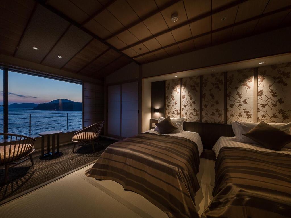 - une chambre avec 2 lits et une vue sur l'eau dans l'établissement Inatori Ginsuiso, à Higashiizu 37 autres photos