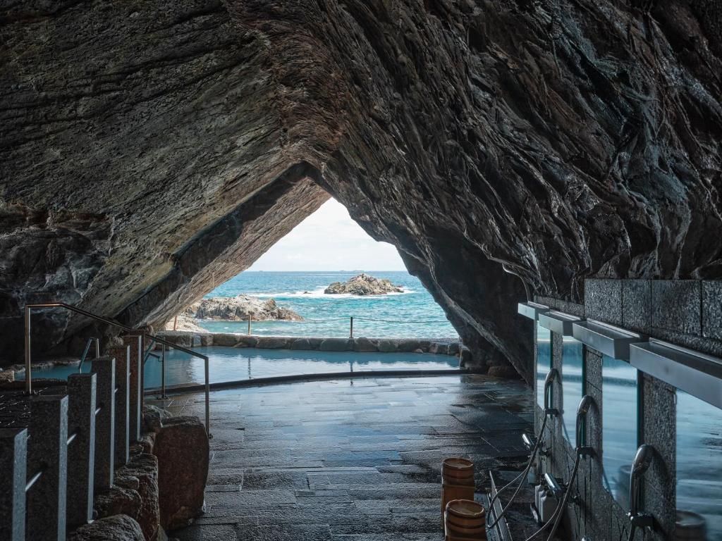 un tunnel menant à l'océan à travers un mur de rochers dans l'établissement Hotel Urashima, à Katsuura