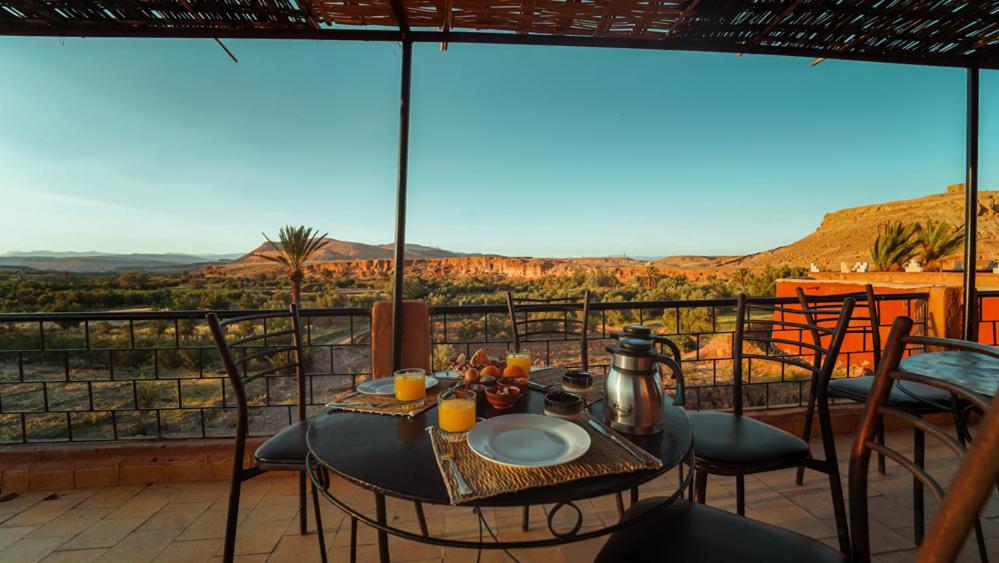 une table et des chaises sur un balcon avec vue dans l'établissement Riad Zaytoune, à Ouarzazate