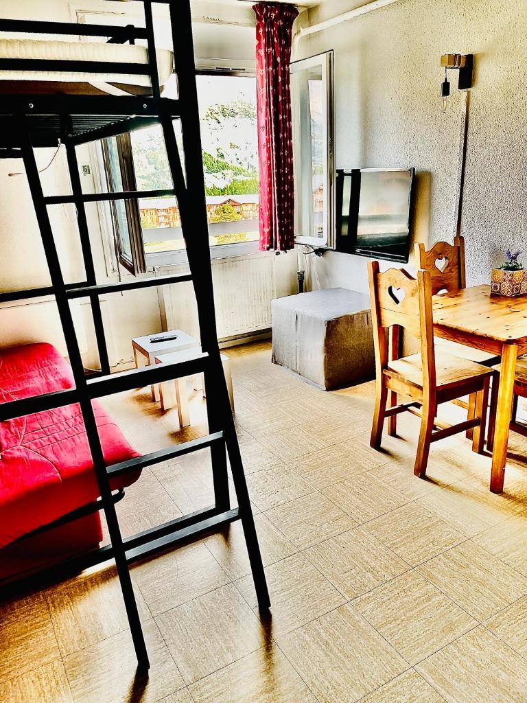 - une chambre avec des lits superposés et une table dans l'établissement Exceptionnel Studio Le petit dortoir wifi parking gratuit vue incroyable sur le pic au pied des pistes de superdevoluy, à Saint-Étienne-en-Dévoluy