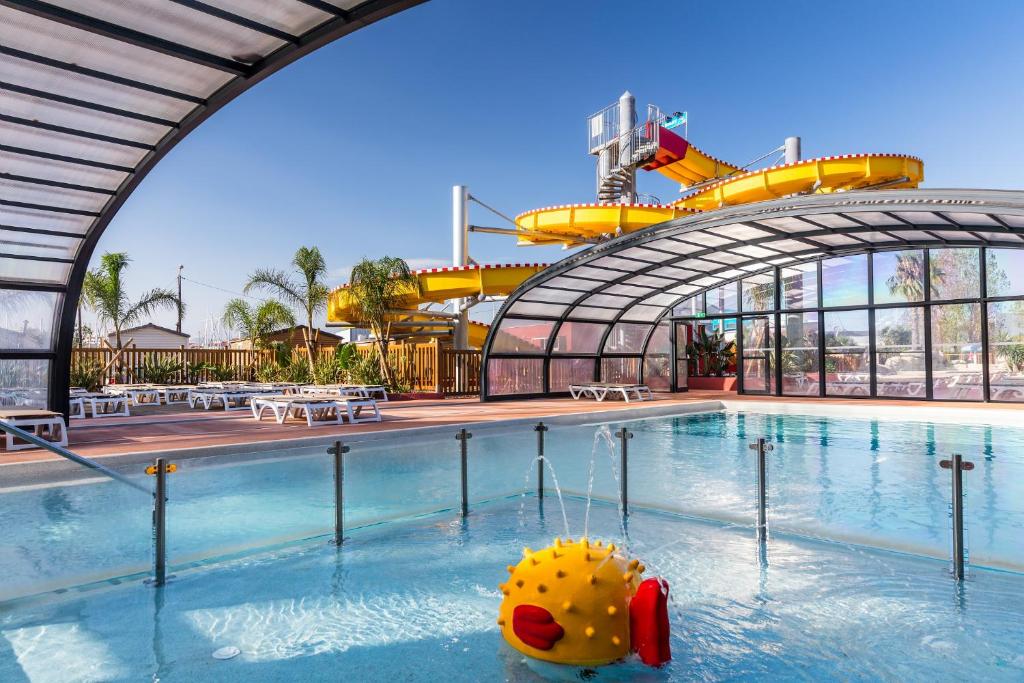 une piscine dans un parc à thème avec un canard en caoutchouc dans l'eau dans l'établissement family's dream p16 la Marina de canet, à Canet