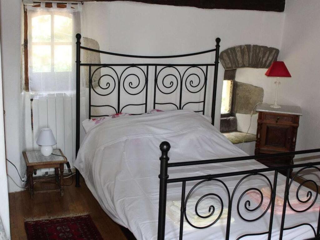 - une chambre avec un lit noir et une couette blanche dans l'établissement La Patouille Comfortable holiday residence, à Aujac