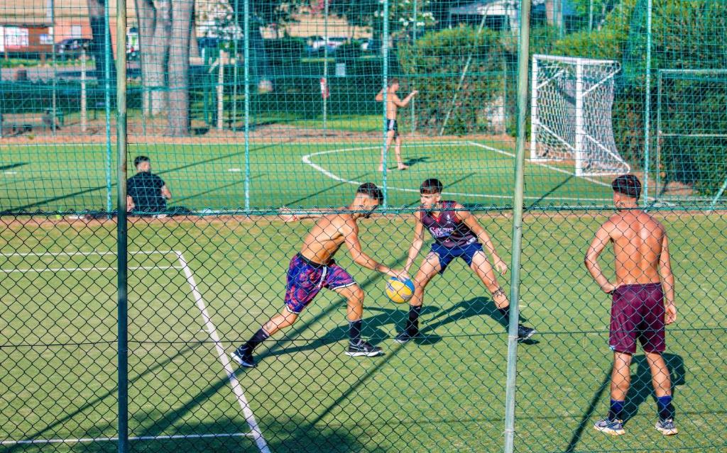 un groupe d'hommes jouant au football dans l'établissement Village with swimming-pool in Montalto Marina just 100 meters from the beach, mobile homes with air conditioning and private outdoor area, à Torre di Montalto