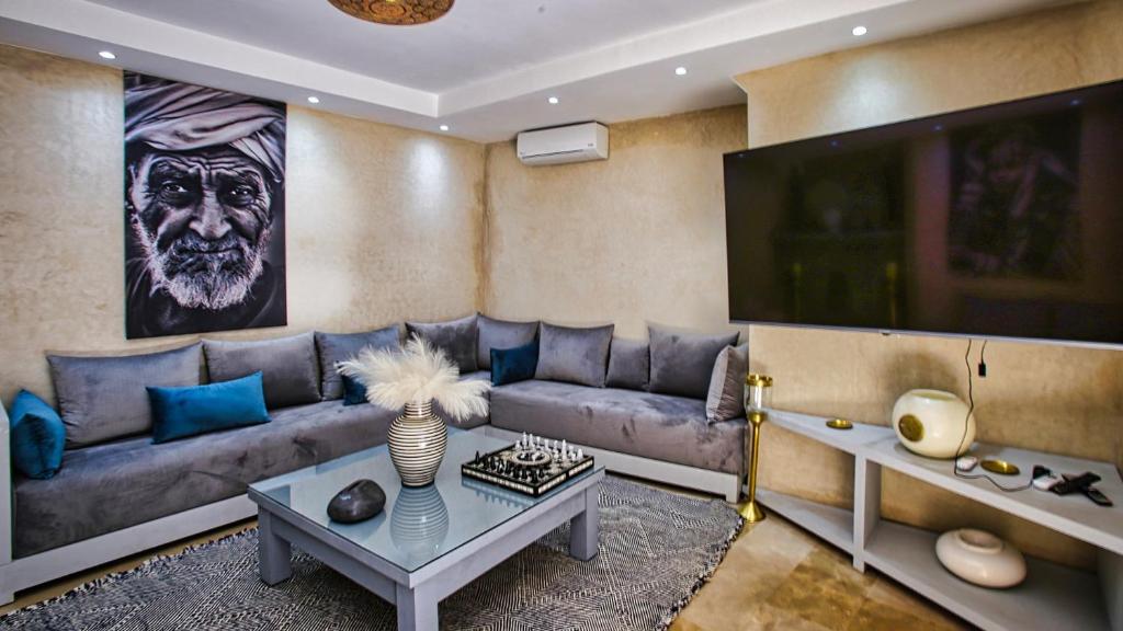 un salon avec un canapé et une télévision dans l'établissement Riad RIM, à Marrakech