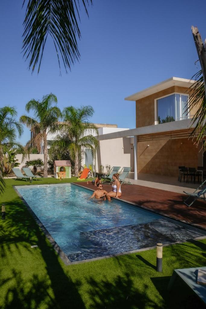 une famille dans la piscine d'une maison dans l'établissement Villa Vannì, à Menfi