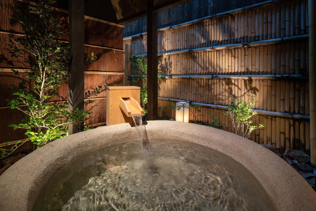 - un bain d'oiseaux avec une fontaine dans le jardin dans l'établissement Nazuna Kyoto Higashi Honganji, à Kyoto