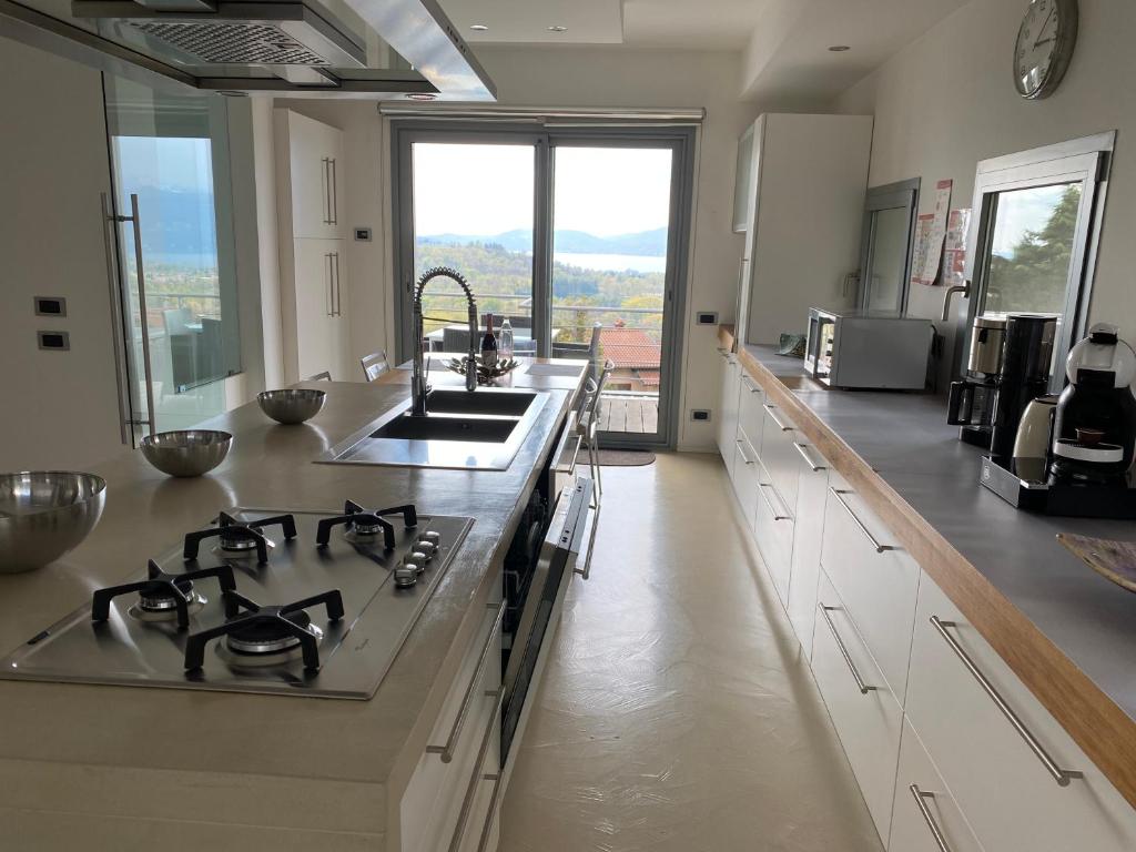 une cuisine avec un évier et une cuisinière four supérieur dans l'établissement Villa Panoramica Cardana, à Besozzo
