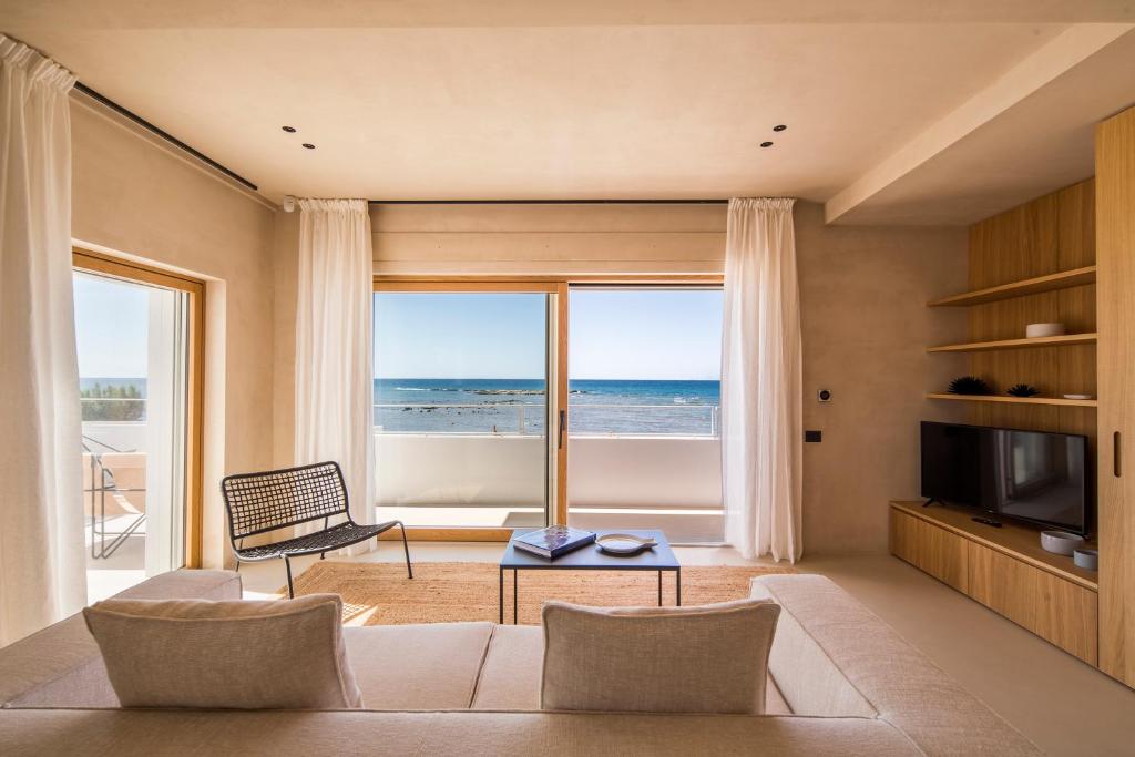 un salon avec un canapé et une vue sur l'océan dans l'établissement Calitro Mare, à Torre Ovo