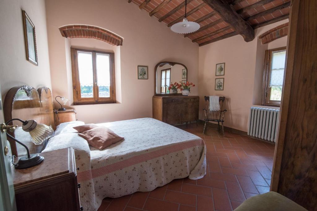 une chambre avec un lit et un miroir dans l'établissement Heated pool - Arte e Terme immerse nella natura, à Massa e Cozzile