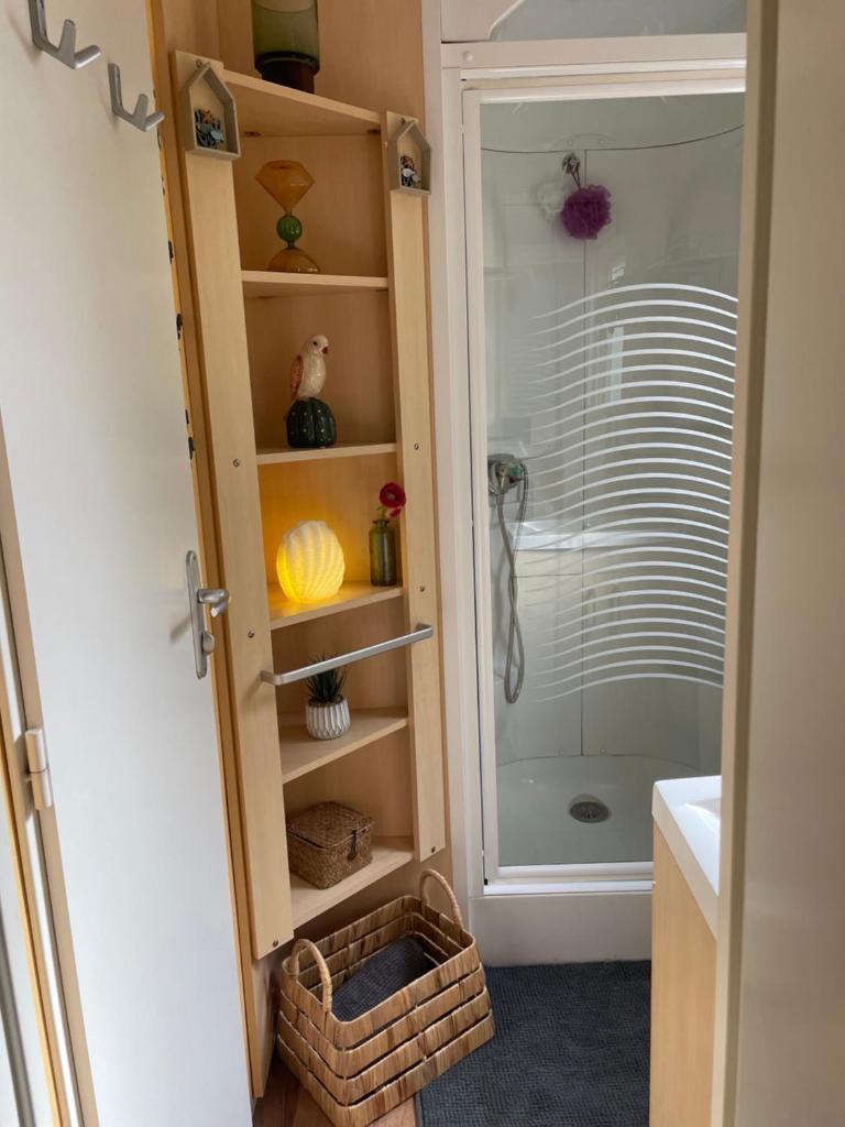 une salle de bain avec douche et porte vitrée dans l'établissement Coquet mobilehome 8 places, à Puget-sur Argens