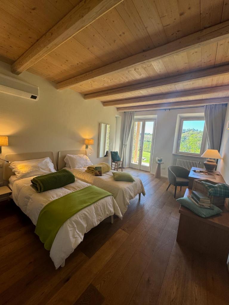 une chambre avec deux lits et une grande fenêtre dans l'établissement Villa La Ginestra Piemonte with private pool, à Bistagno