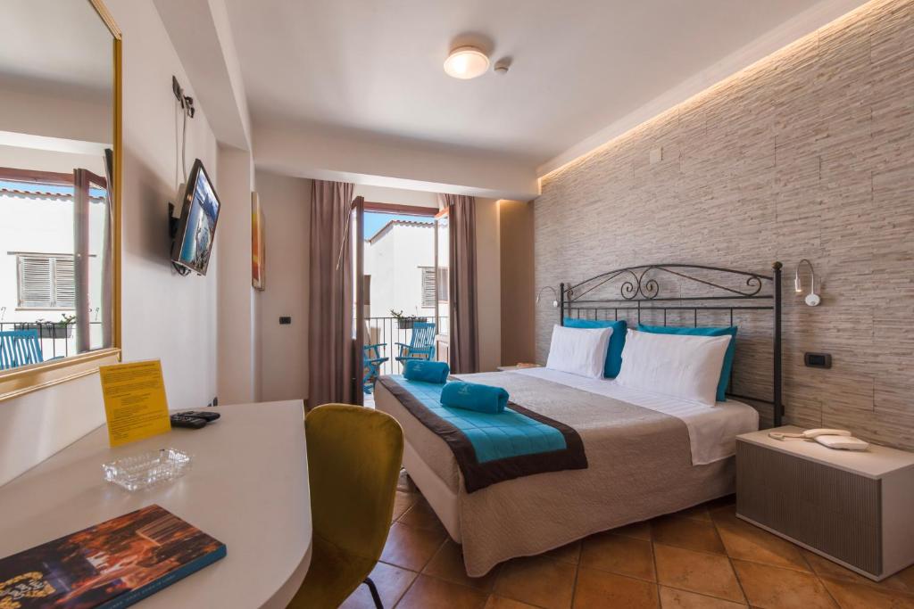 une chambre d'hôtel avec un lit et un bureau dans l'établissement Hotel Trinacria, à San Vito Lo Capo