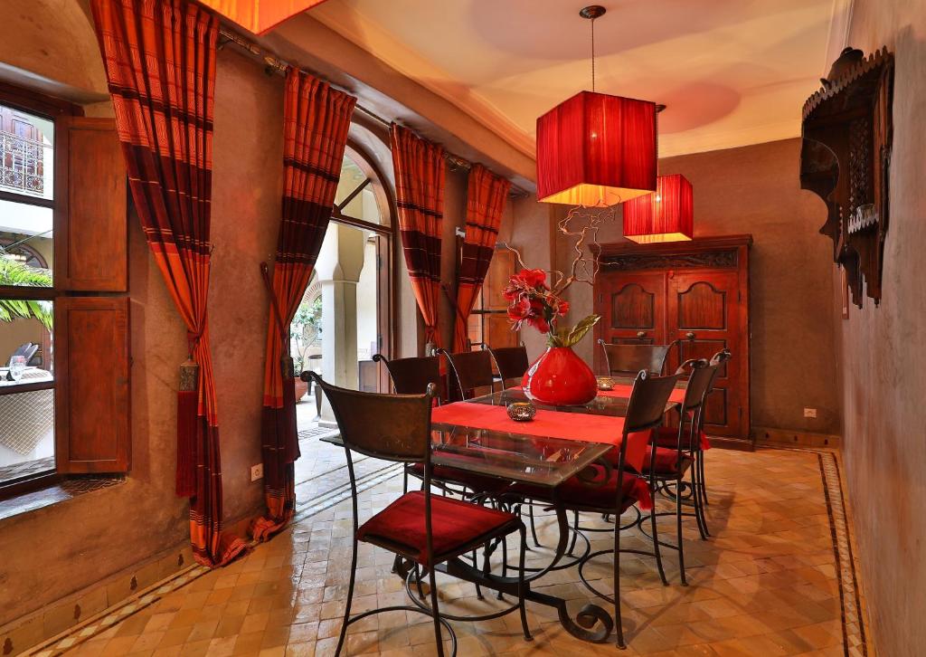 une salle à manger avec une table et des chaises rouges dans l'établissement Riad Zayane, à Marrakech