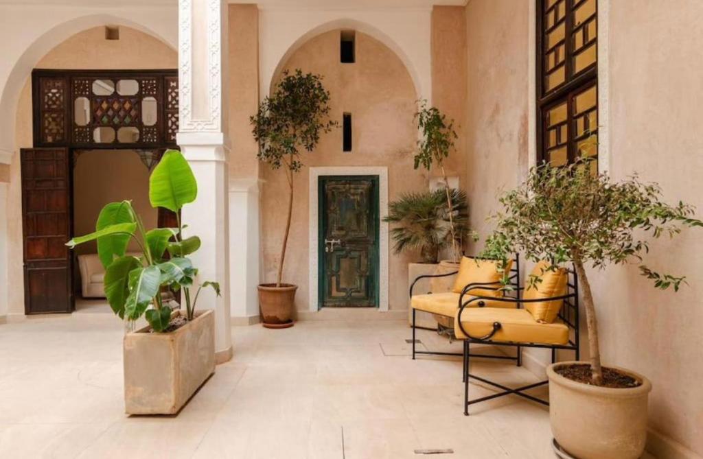 un hall avec des plantes et une porte dans un bâtiment dans l'établissement Riad Manzal, à Marrakech