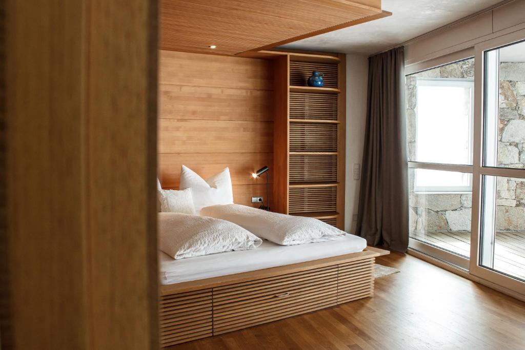 une chambre avec un lit avec des oreillers blancs dans l'établissement Turm Chalet, à Laces